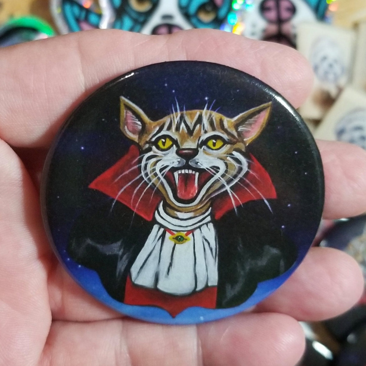 Large 2.25 inch button pin featuring Vlad the vampire cat by Michele The Painter