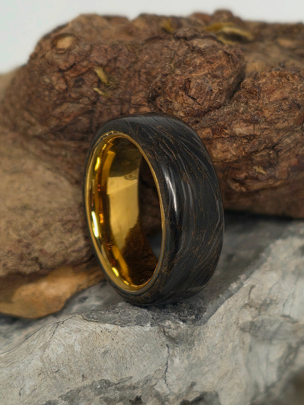Gold-infused carbon fiber ring over a gold-plated tungsten core by Cameron Senft Designs, size 7