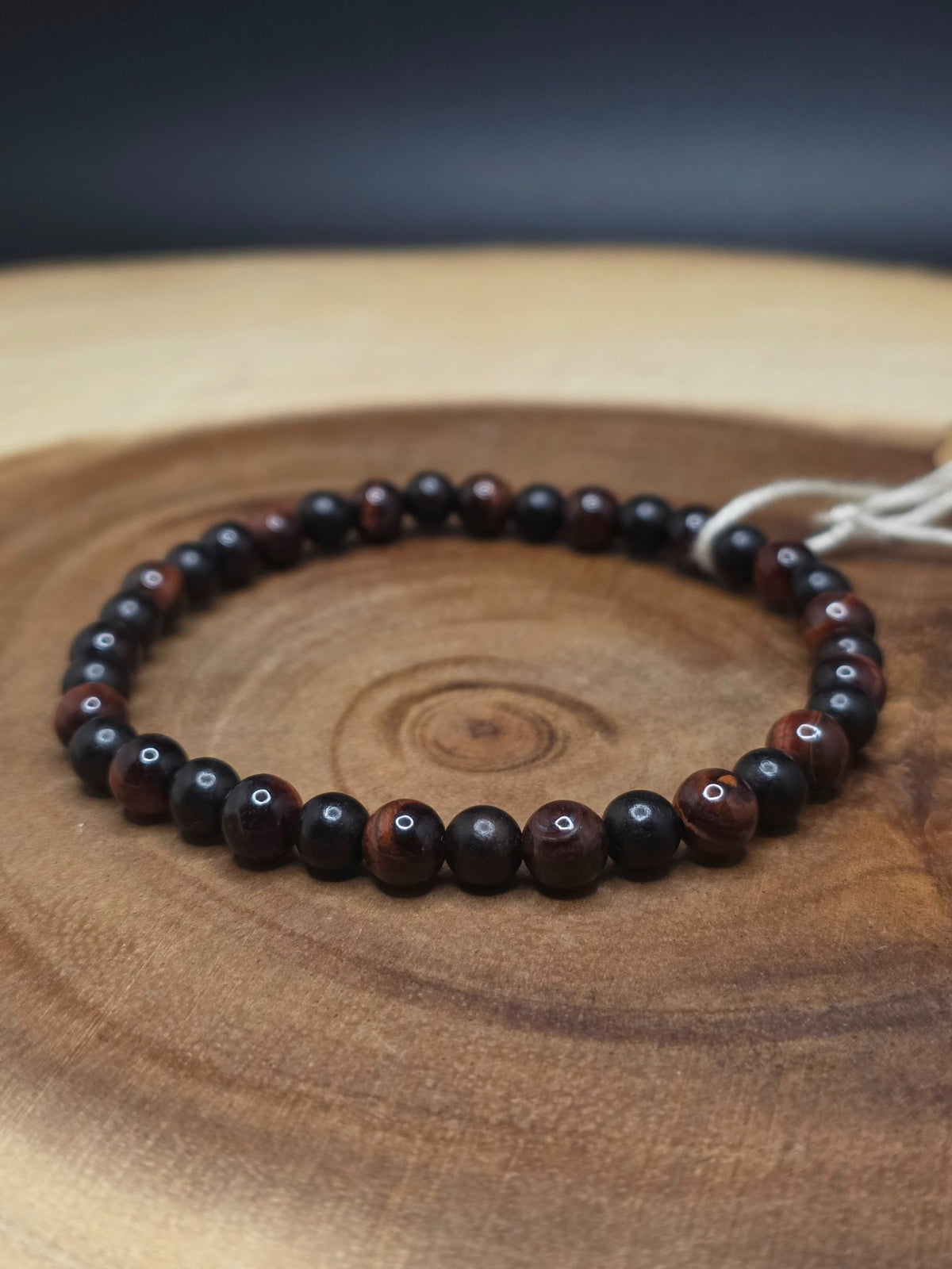 Stretch bracelet of 6mm red tiger's eye and ebony wood beads by Cameron Senft Designs, medium-large