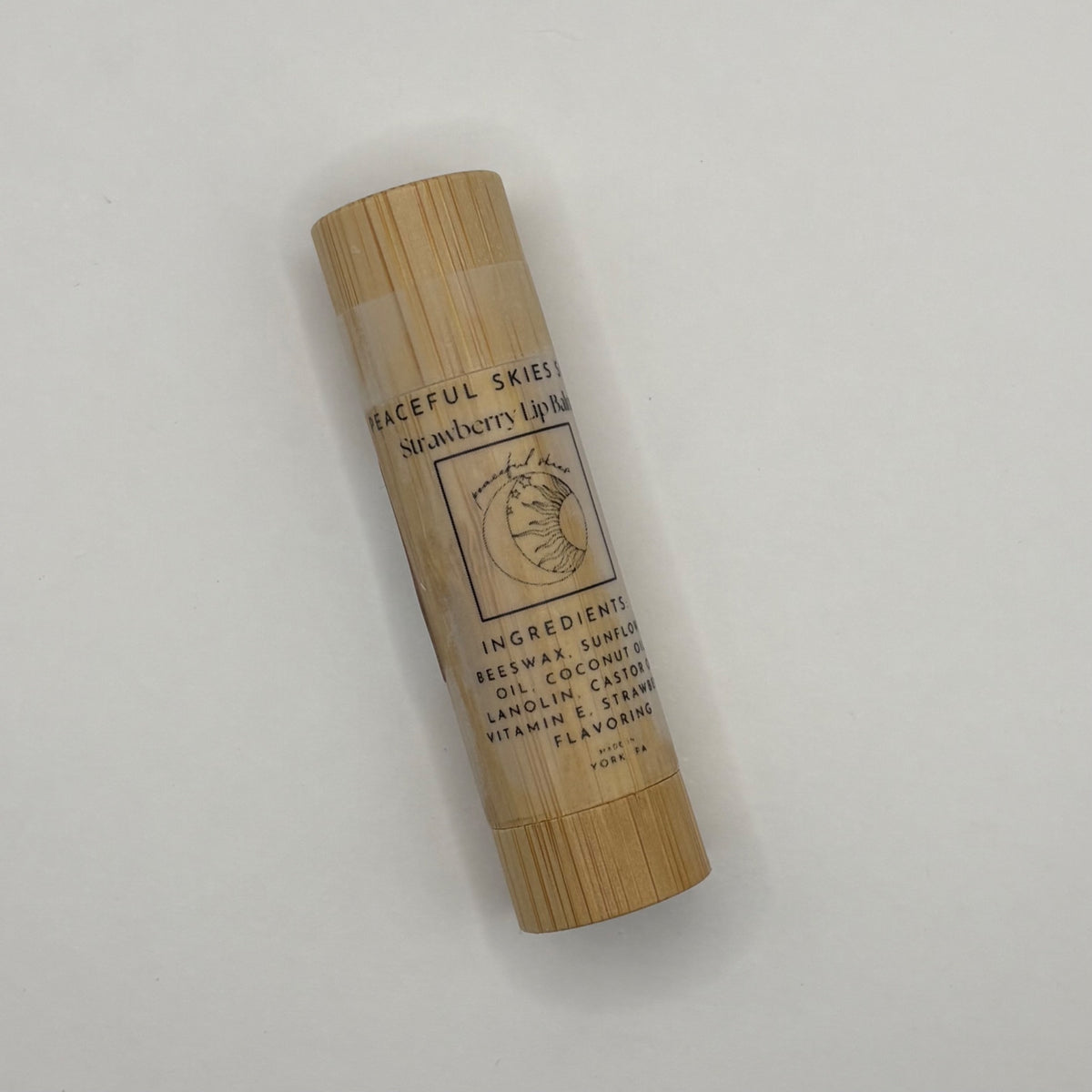 Strawberry beeswax lip balm in a bamboo container by Peaceful Skies of York
