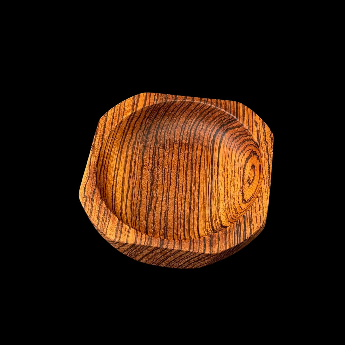 Third view of the hand-turned zebrawood bowl showing its striped West African grain