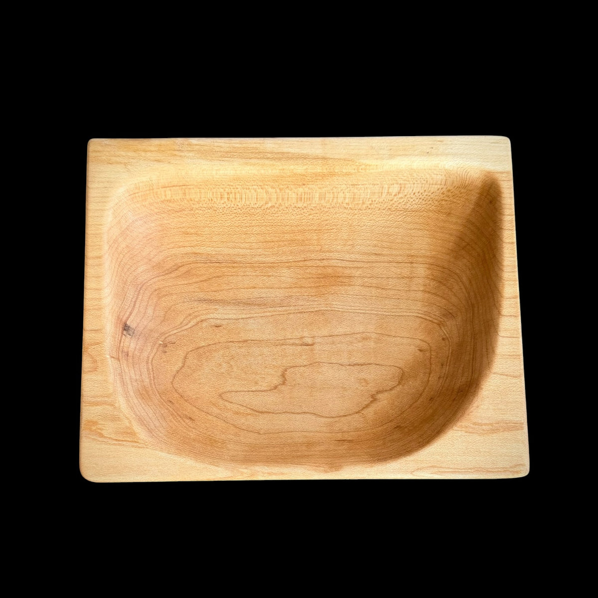 Second view of the honeyed maple dish showing its contrasting black palm feet