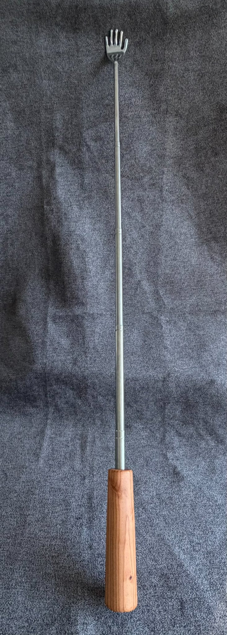 Third view of the hand-turned pine telescoping backscratcher from Sawdust Heaven
