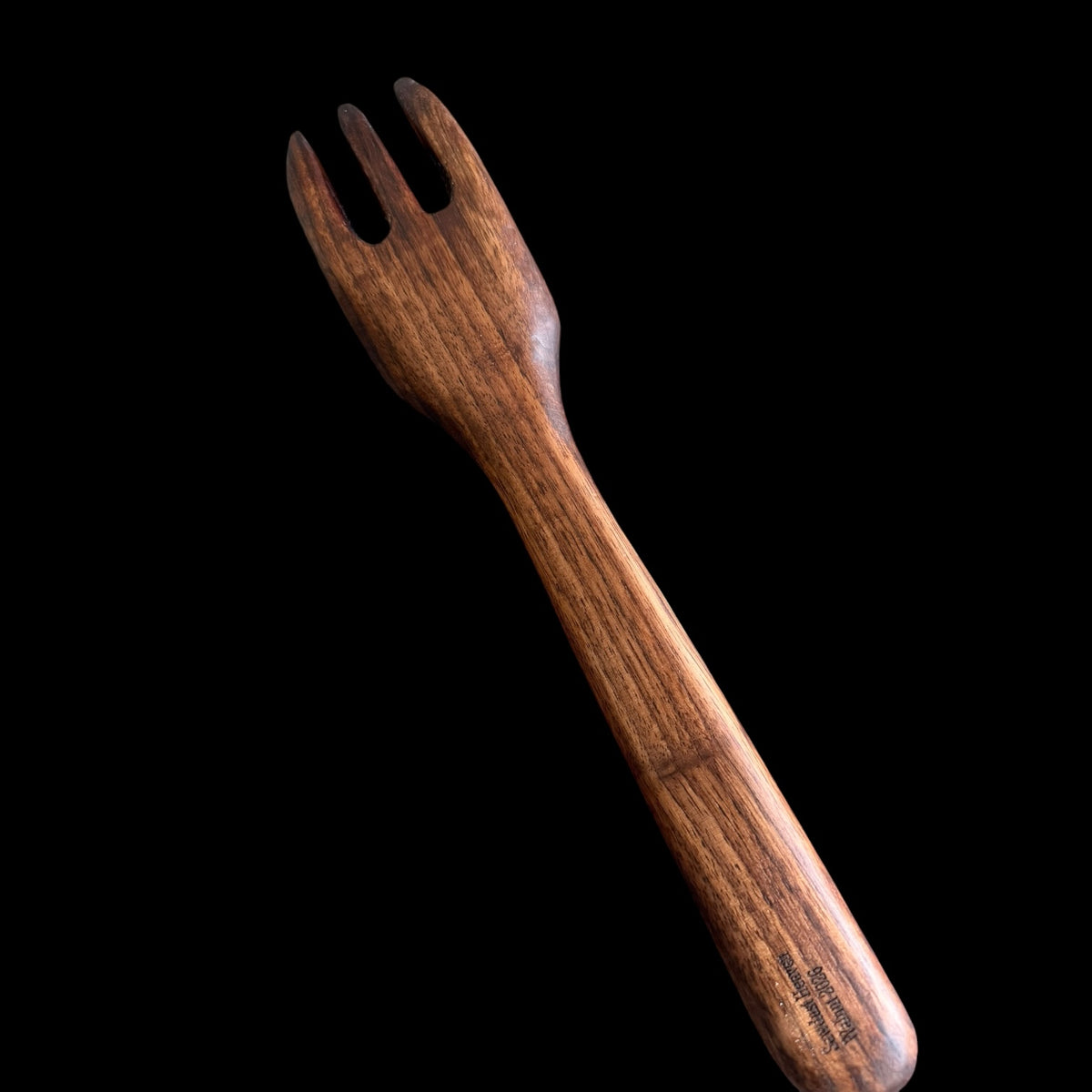 Second view of the carved black walnut fork with its smooth cured finish