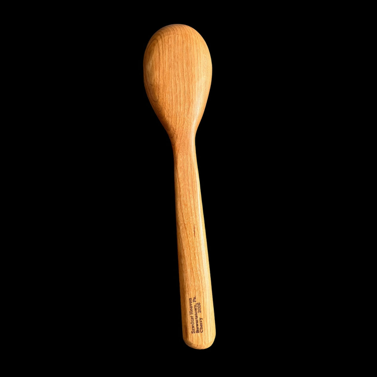 Second view of the hand-carved cherry spoon with its smooth cured finish