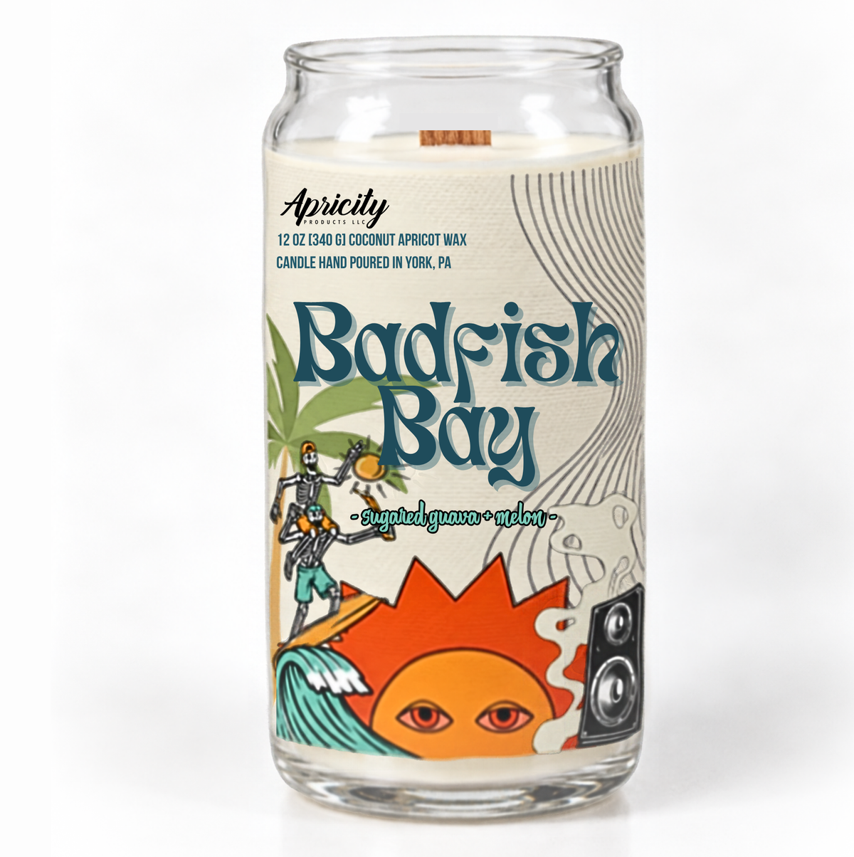 Badfish Bay sugared guava and melon candle in a clear glass can jar with a wooden wick