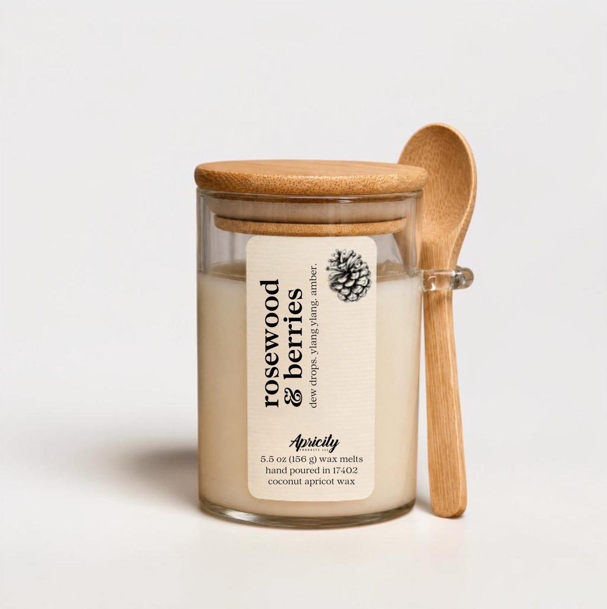 Rosewood and Berries scoopable wax melt in a glass jar with bamboo lid and wooden scoop spoon