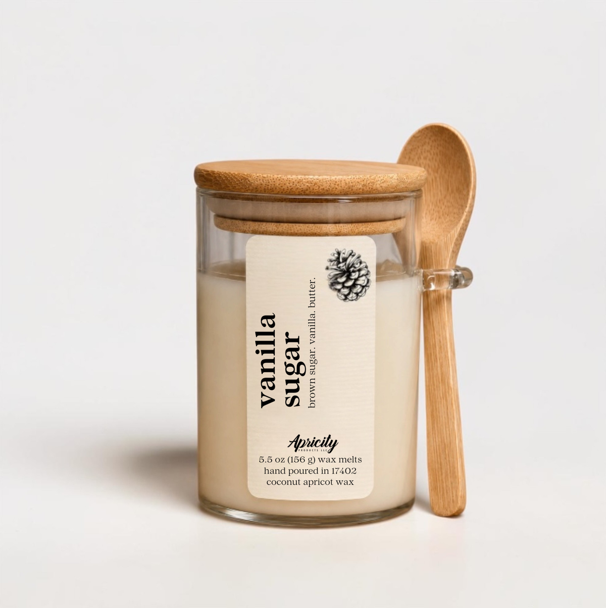Vanilla Sugar scoopable wax melt in a glass jar with bamboo lid and wooden scoop spoon
