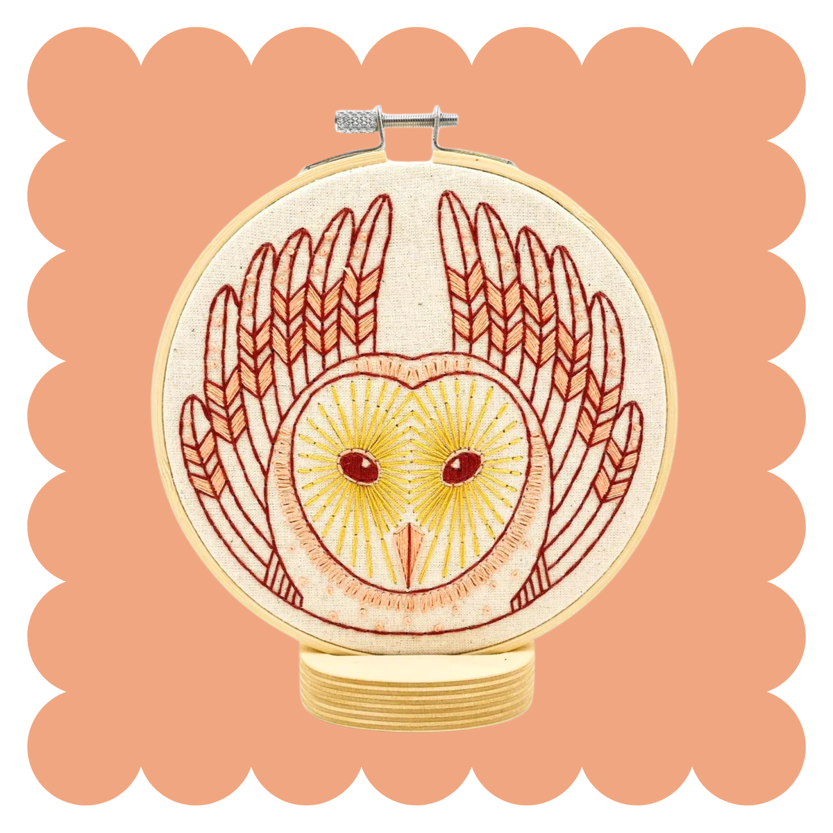 Embroidery hoop with stitched barn owl in brown and rust folk art style