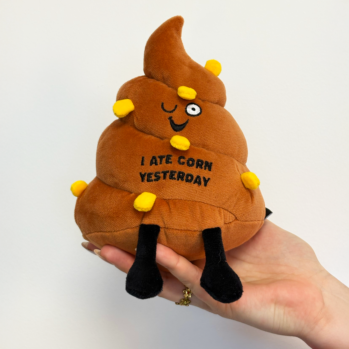 Brown poop plush with 3D corn pieces and embroidered text I Ate Corn Yesterday by Punchkins, view 2