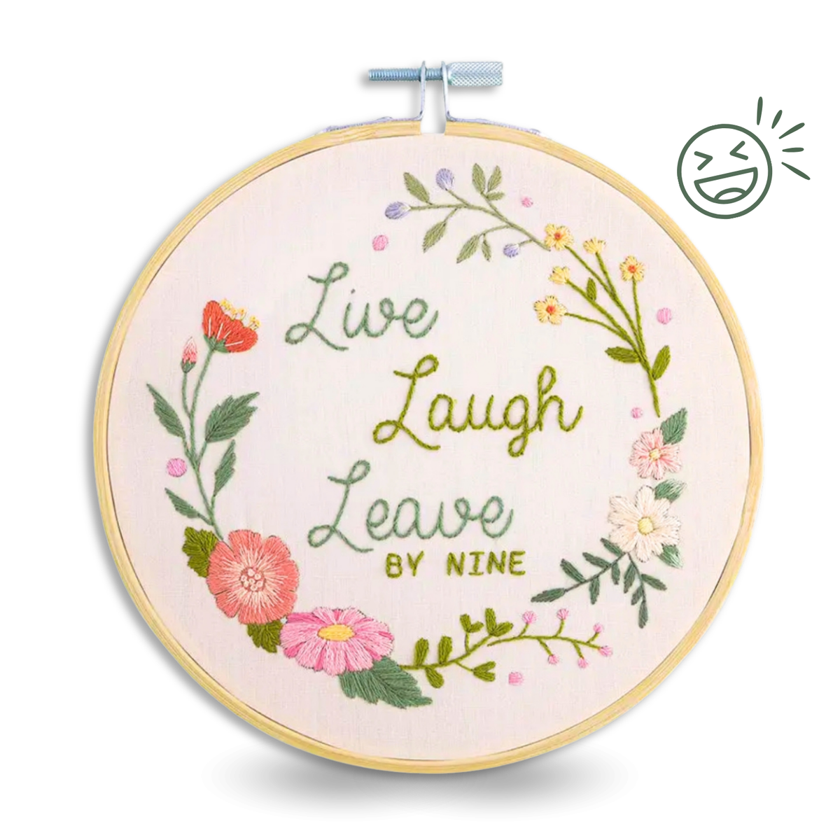 Embroidery hoop with floral ring and green text Live Laugh Leave By Nine