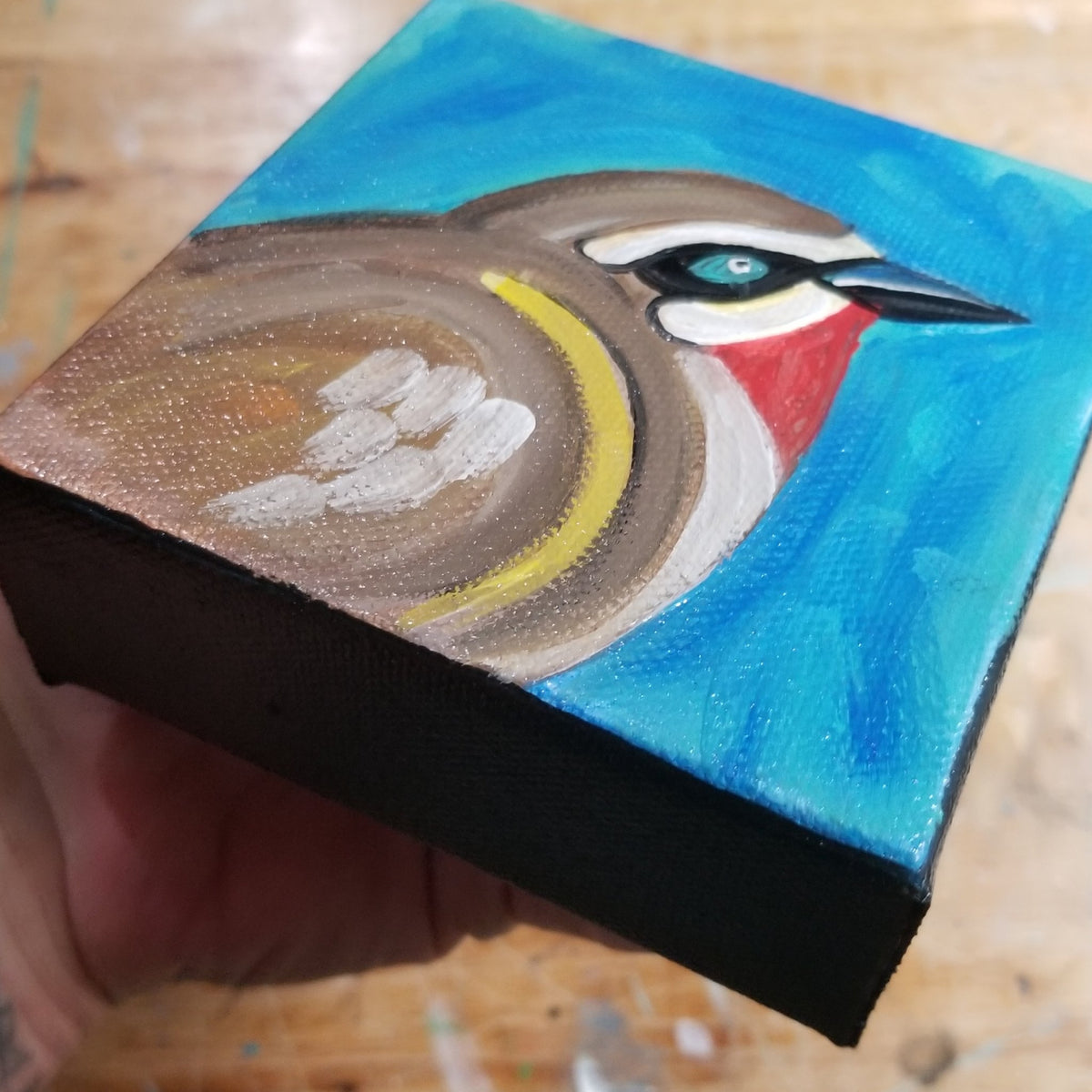 Second view of the ruby throated brown bird painting on its deep canvas