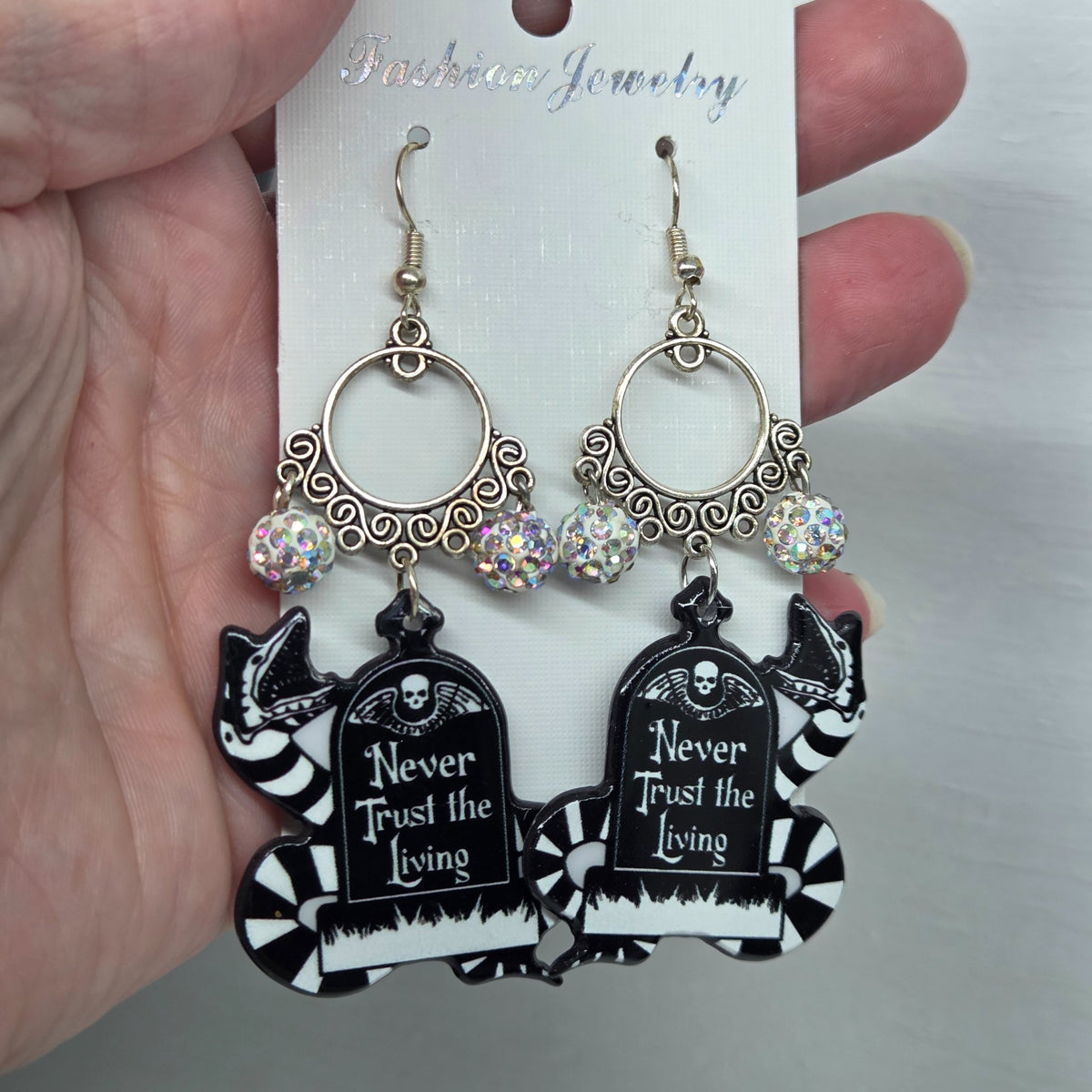 Beetlejuice sandworm earrings measuring three inches from the hook, by The Velvet Viper