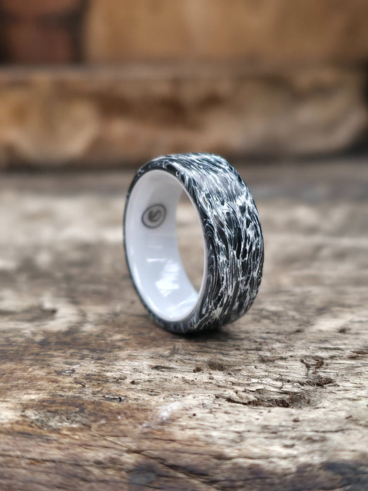 Polar white carbon fiber ring over a white ceramic core by Cameron Senft Designs, size 7