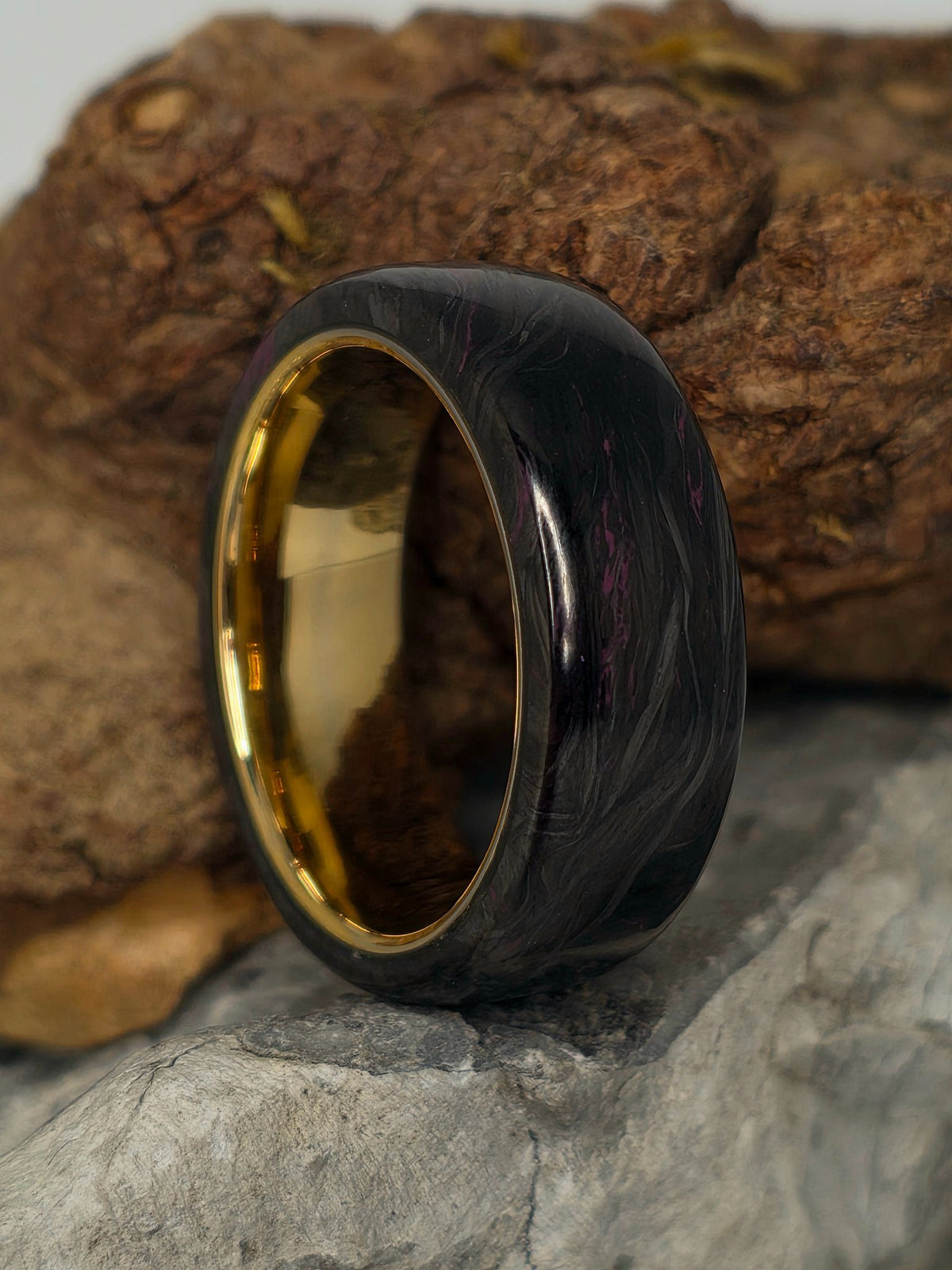Purple resin-infused carbon fiber ring on a gold-plated tungsten core by Cameron Senft Designs, size 10