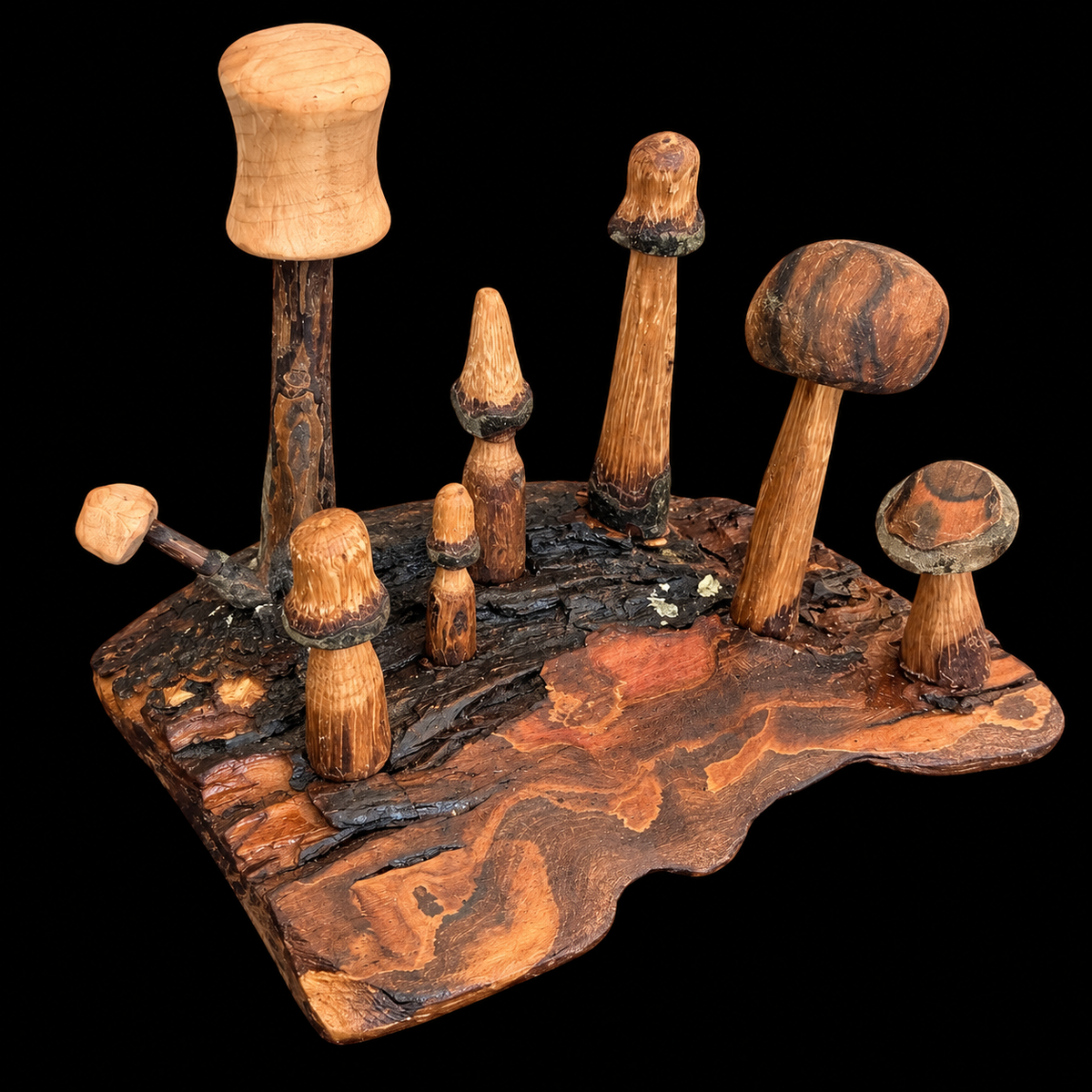 Third view of the carved mini mushrooms arranged on their bark base