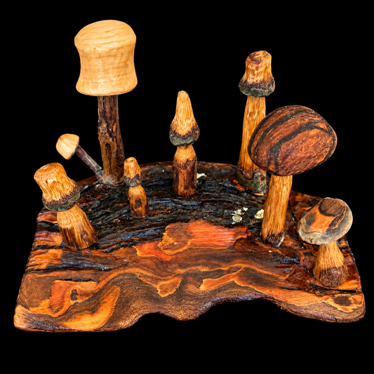 Cluster of hand-carved mini mushrooms nestled on a piece of natural bark by Tina