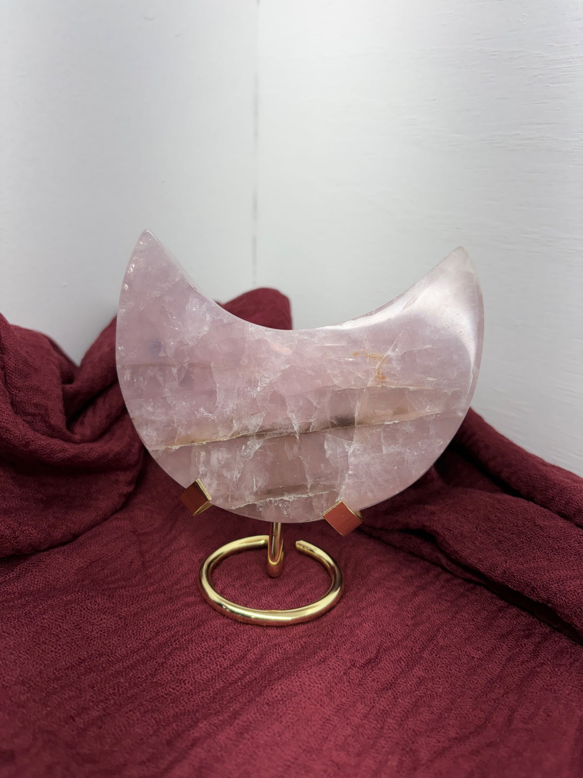 Carved rose quartz crescent moon with display stand, a self-love crystal from Holistic Unicorn