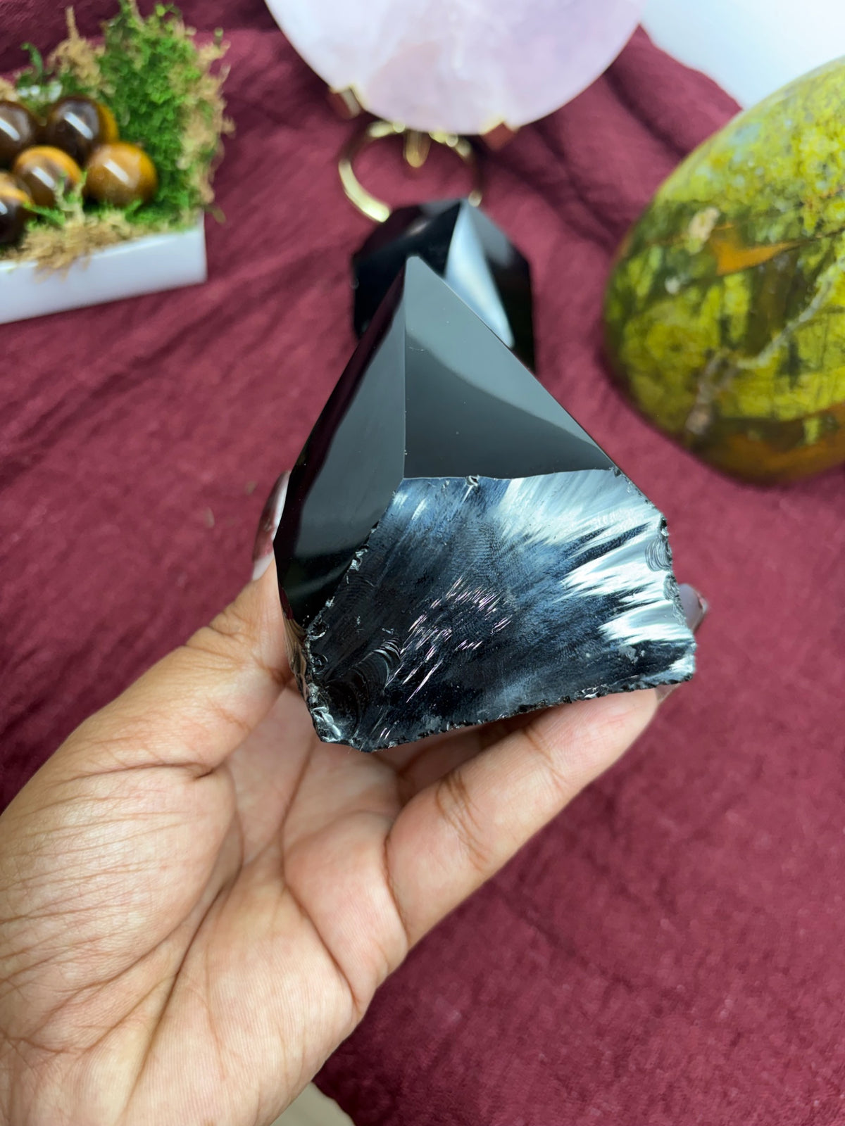 Another view of the black obsidian piece showing its glassy dark surface