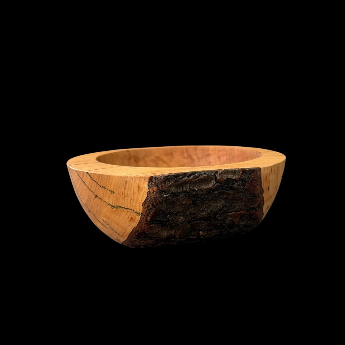 Hand-turned cherry bowl with smooth heartwood and a natural live-edge bark rim by Sawdust Heaven