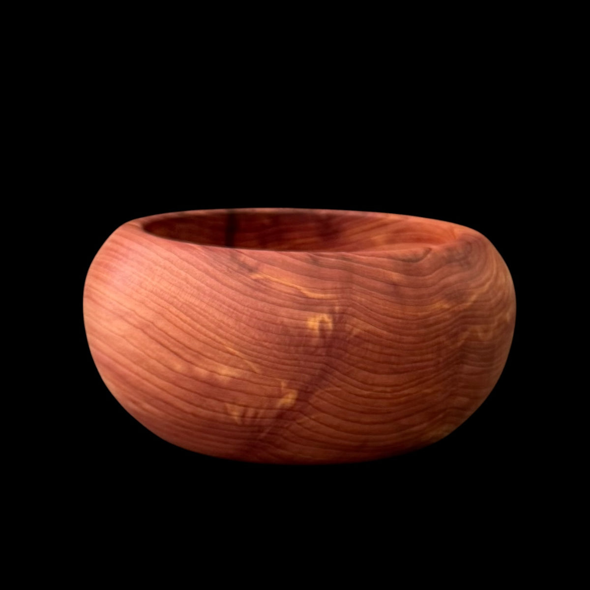Eastern red cedar bowl with vivid crimson hues and dense grain, hand turned by Sawdust Heaven
