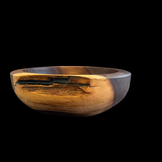 Hand-turned black walnut bowl with dark heartwood, golden sapwood and a black resin live edge by Sawdust Heaven