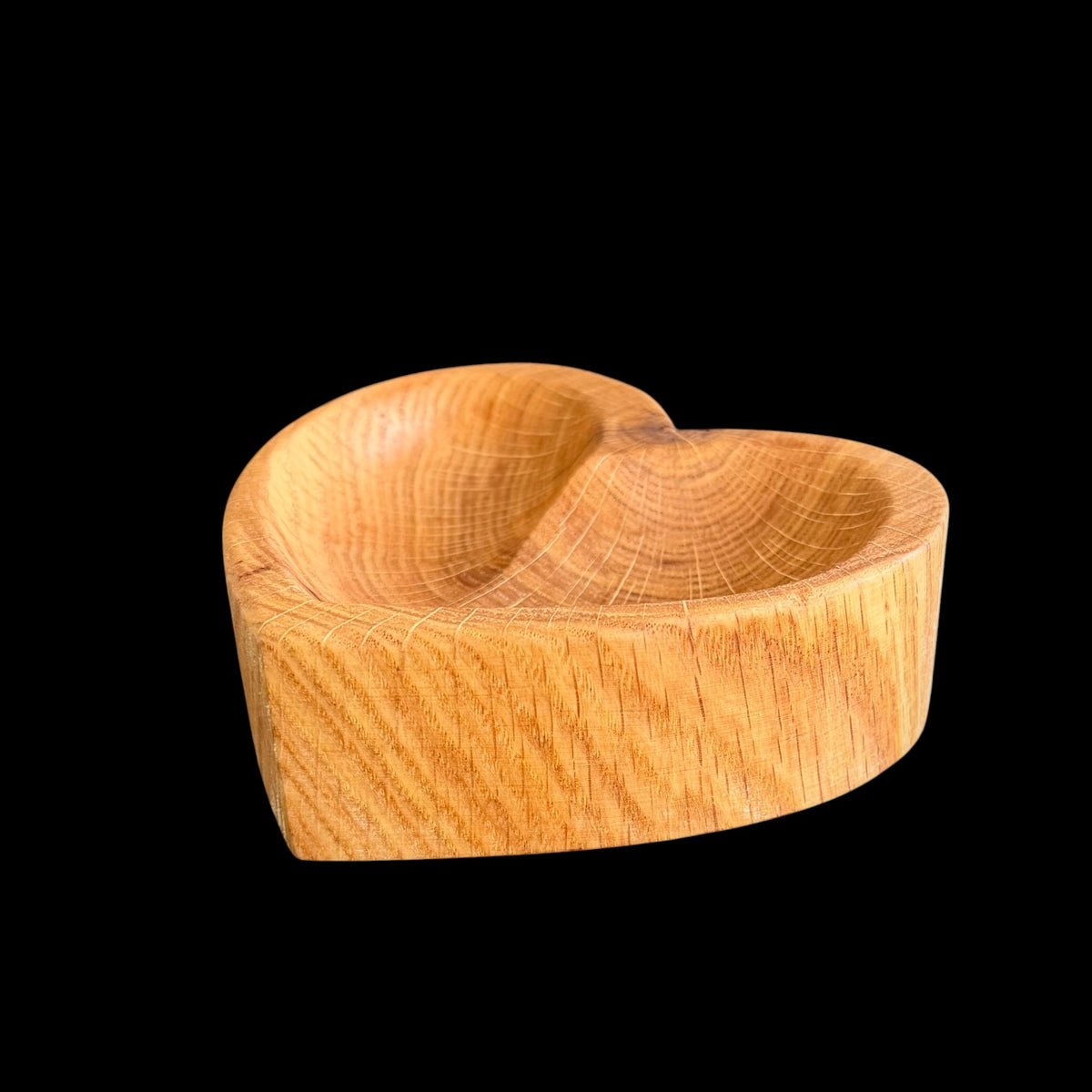Second view of the red oak heart dish showing its sunburst-like grain lines