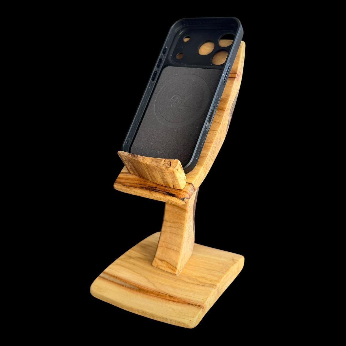 Third view of the phone stand showing the natural bark strip on its back