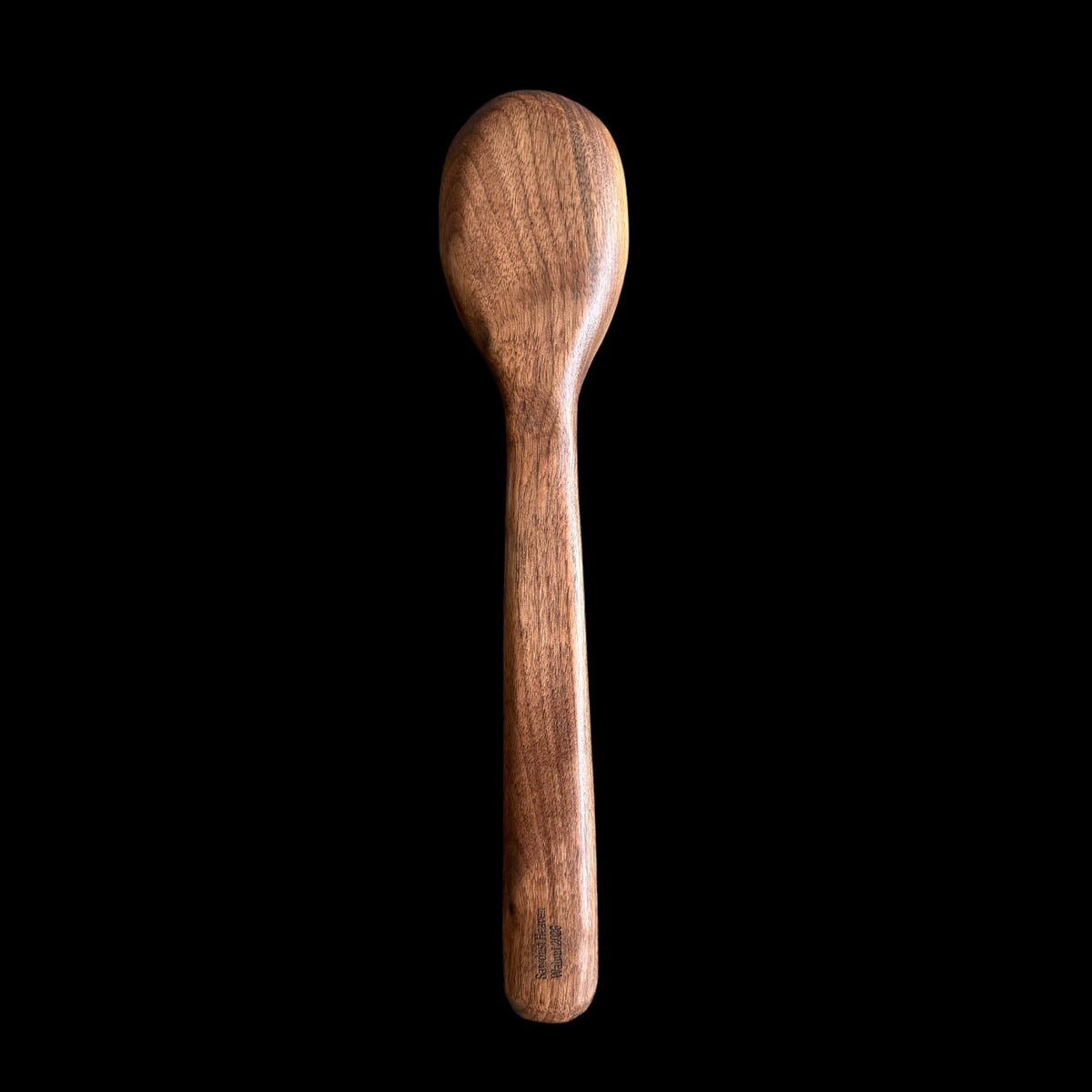 Second view of the carved black walnut spoon and its burnished finish