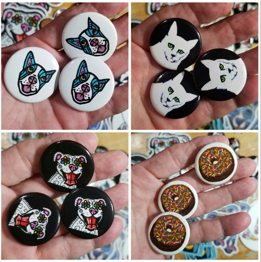 Assorted button pins made from original paintings by Michele The Painter, colors and styles vary