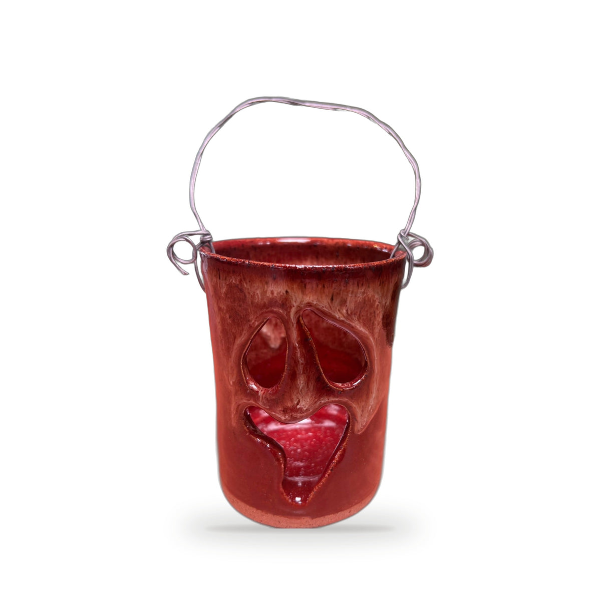 Handmade dark rust red ceramic Halloween luminary with carved face and silver wire handle by ABeYOUtifulMind