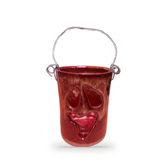 Handmade dark rust red ceramic Halloween luminary with carved face and silver wire handle by ABeYOUtifulMind