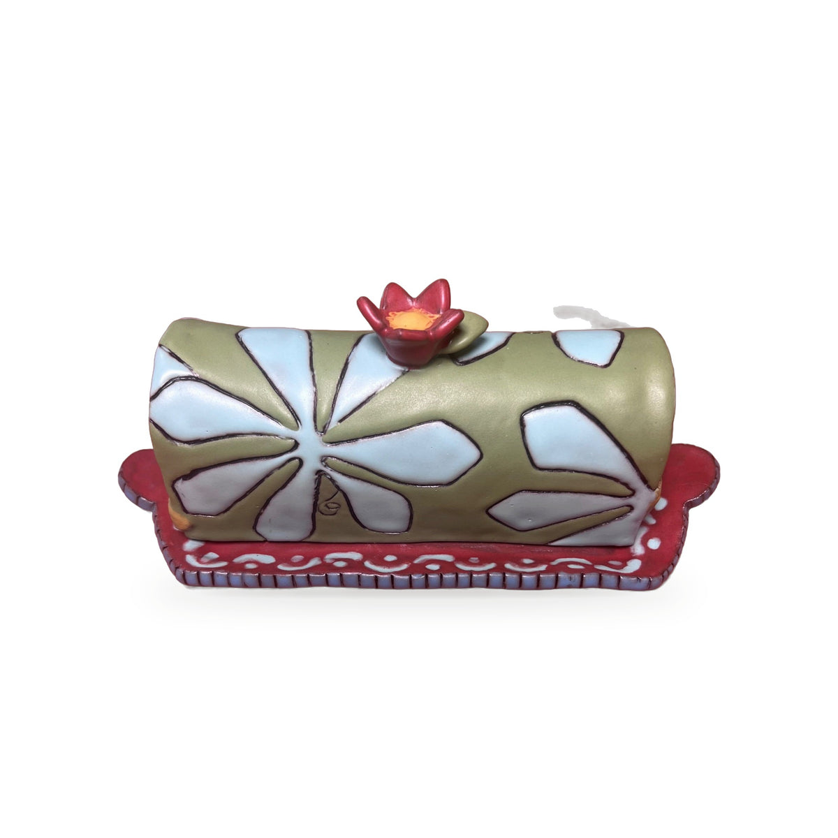 Floral butter dish front view showing carved white flower pattern and red painted tray