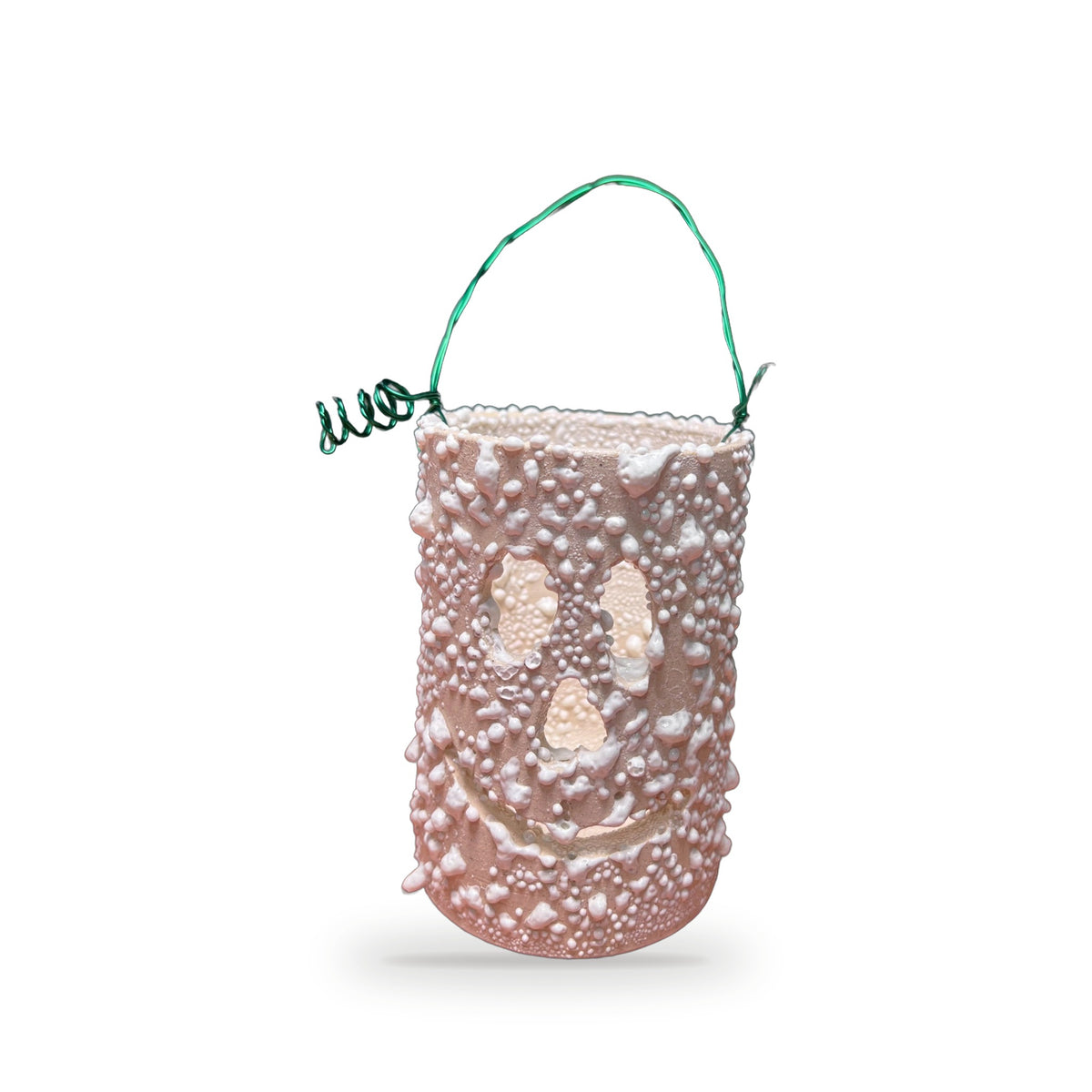 Handmade textured ceramic ghost lantern in pale pink with bumpy surface, cutout ghost face, and green wire handle by ABeYOUtifulMind