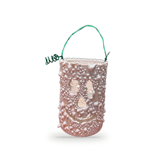 Handmade textured ceramic ghost lantern in pale pink with bumpy surface, cutout ghost face, and green wire handle by ABeYOUtifulMind