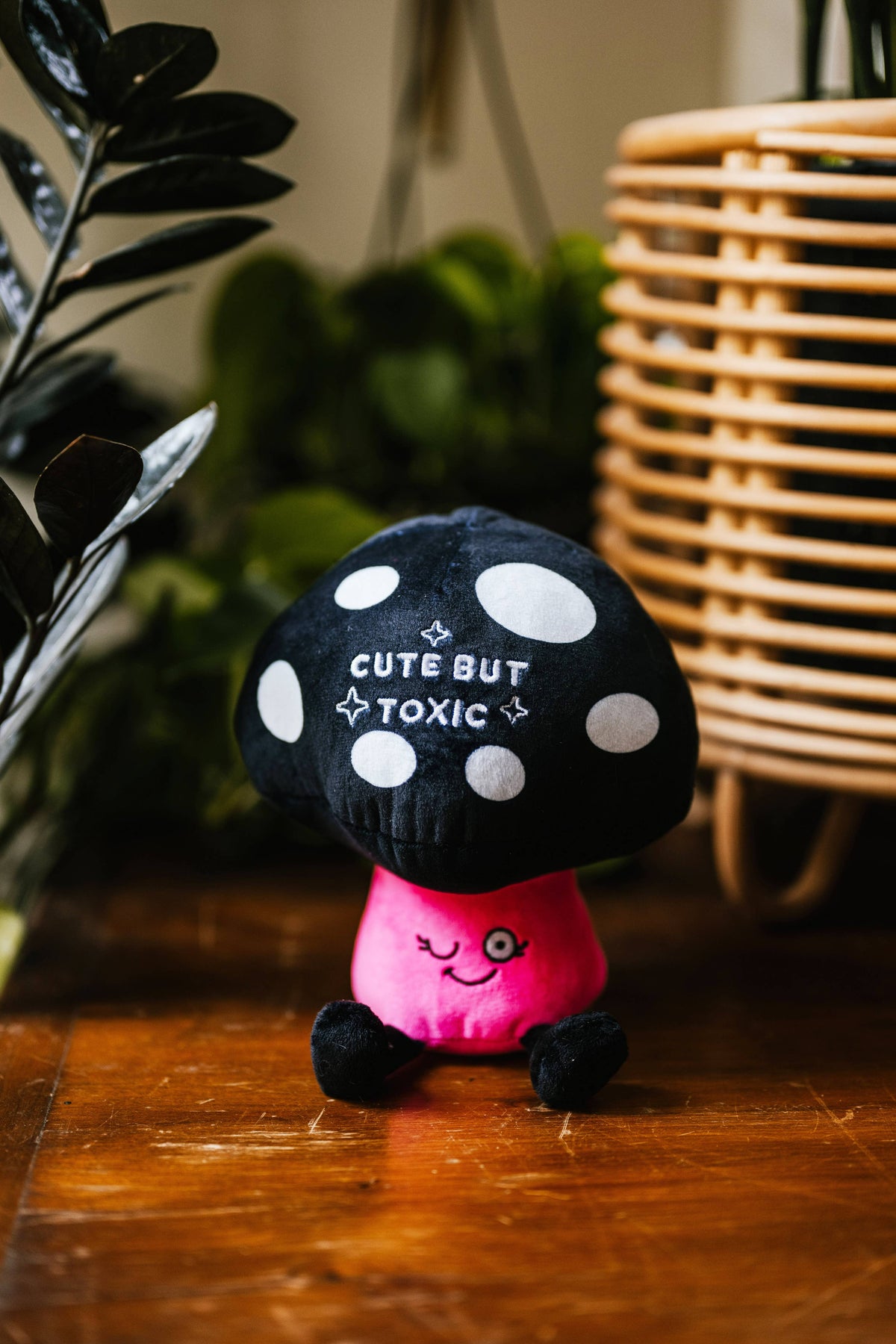 Black spotted mushroom plush with pink body and embroidered text Cute But Toxic by Punchkins, view 2