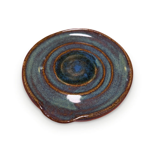 Handmade ceramic spoon rest with blue-green swirl glaze and amber rim by ABeYOUtifulMind